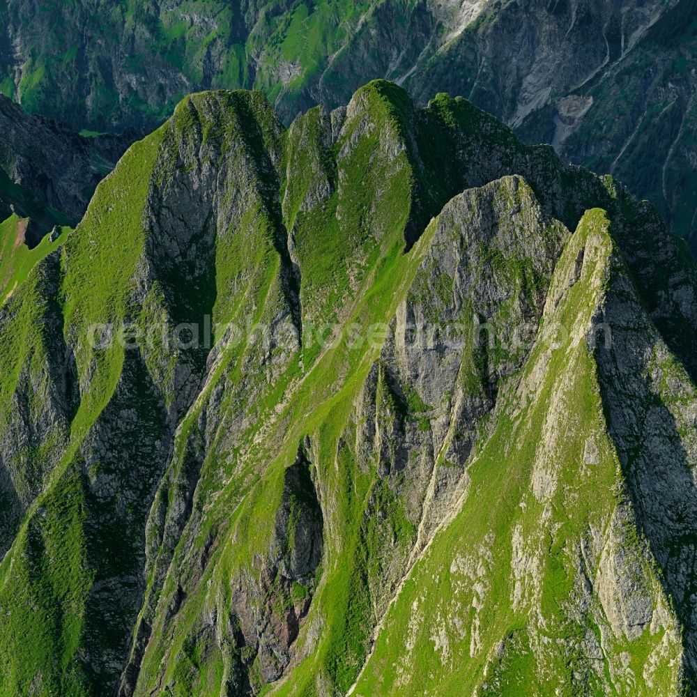 Aerial image Oberstdorf - White and snowy peaks des Hoefats in the rocky and mountainous landscape in Oberstdorf in the state Bavaria. Hoefats, the Allgaeu Alps, Germany The 4 peaks of Hoefats mountain are the most prominent ones in the Allgaeu Alps. Here hard limestone and soft marl aggregate, and due to the latteras moistness, the very steep ridges are overgrown with a thick layer of grass. That makes the Allgaeuer Grasberge (Allgaeu grass mountains) unique within the Alps