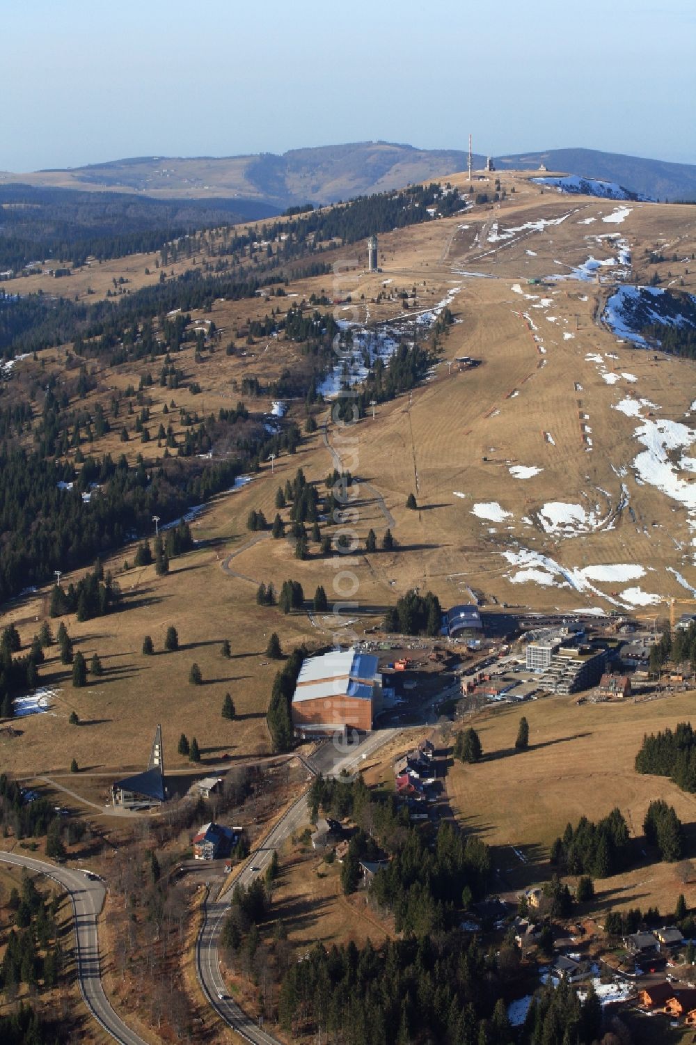 Aerial image Feldberg (Schwarzwald) - Almost without snow is the summit region of the highest mountain in the Black Forest, the Feldberg in Feldberg (Schwarzwald) in Baden-Wuerttemberg. In time for the winter season and the Christmas holidays the car park has been finished on the Seebuck and the new ski lift is ready to work. But there is no snow for winter sports.