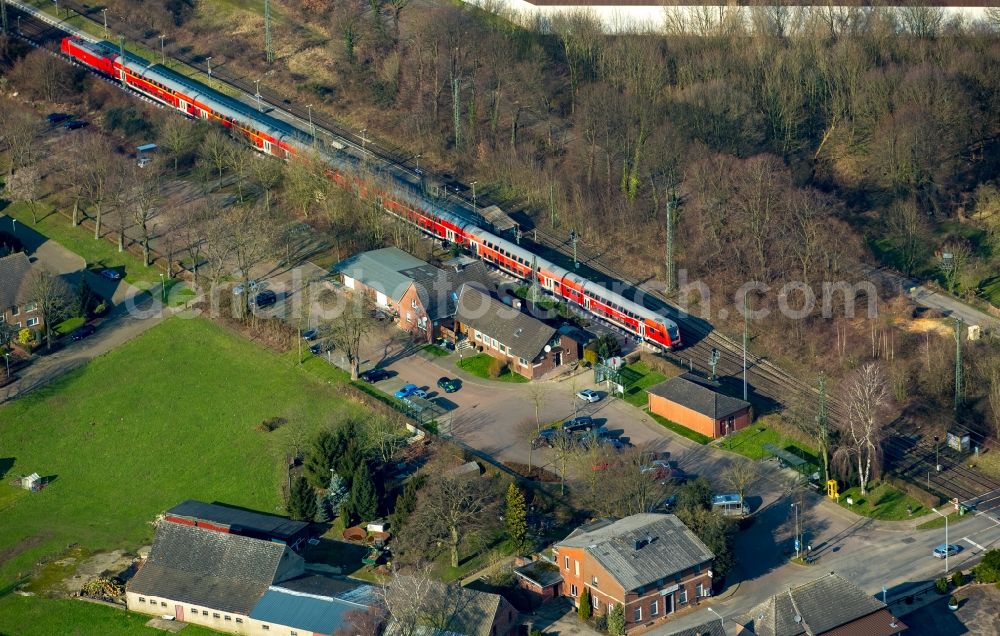 Aerial image Rees - Track history and railway station of the Deutsche Bahn Empel-Rees with red regional train in Rees in North Rhine-Westphalia