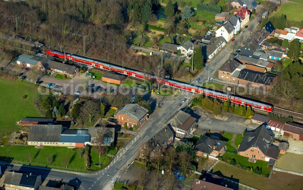 Rees from the bird's eye view: Track history and railway station of the Deutsche Bahn Empel-Rees with red regional train in Rees in North Rhine-Westphalia