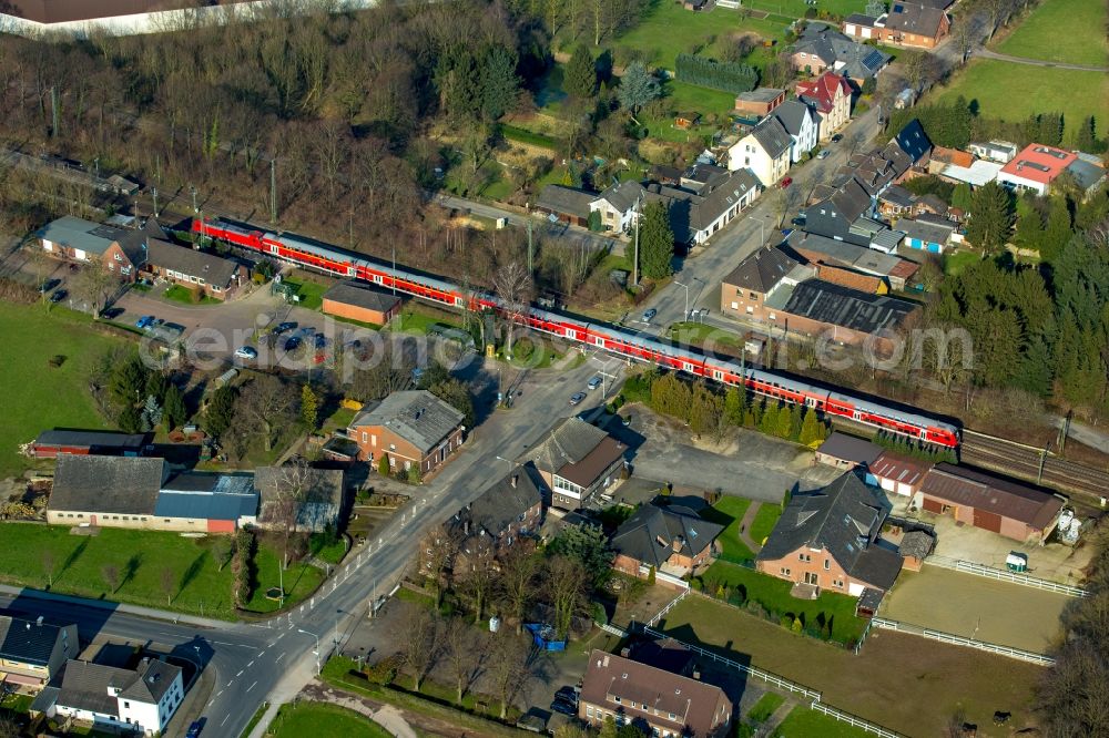 Aerial image Rees - Track history and railway station of the Deutsche Bahn Empel-Rees with red regional train in Rees in North Rhine-Westphalia