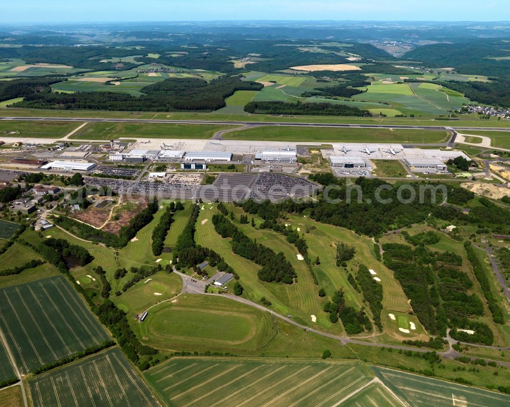 Lautzenhausen from above - Golf course and airport Frankfurt-Hahn in Lautzenhausen in the state of Rhineland-Palatinate. The airport (ICAO-Code:EDFH, IATA-Code: HHN) is a converted military air base, now a minor international airport and fifth largest cargo airport of Germany. The 9-hole golf course is right adjacent to it (in the East)