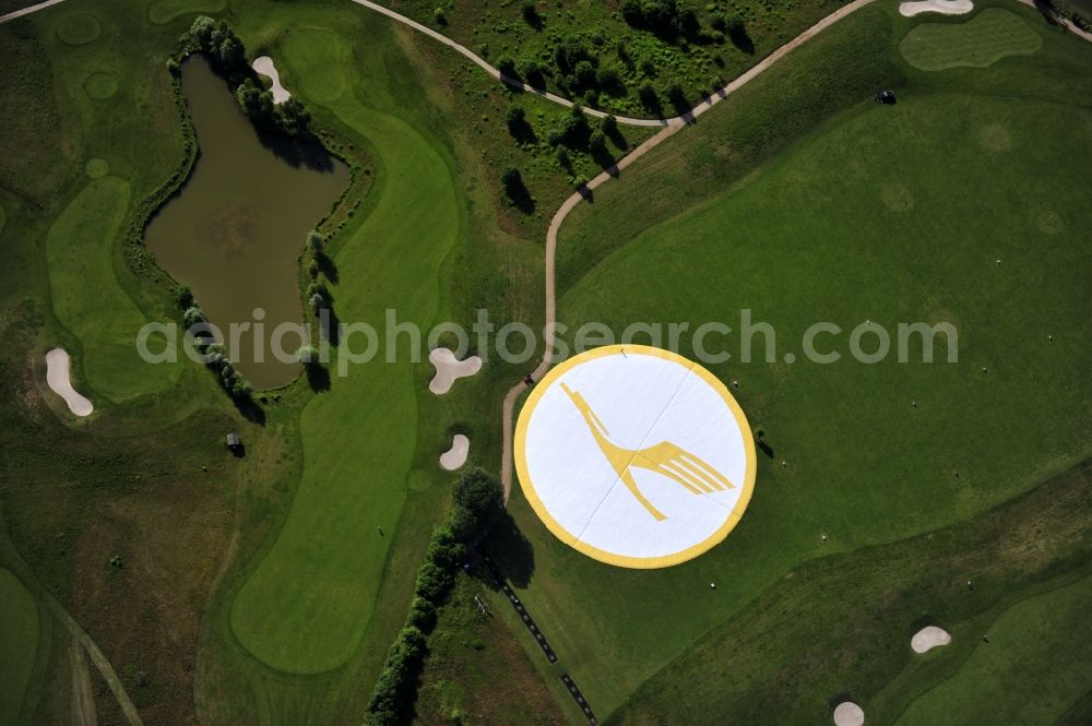 Groß Kienitz from the bird's eye view: View the golf course Great Kienitz southeast of the airport BER Construction. Pictured are on the occasion of the Lufthansa Airlines media Cup placed logos