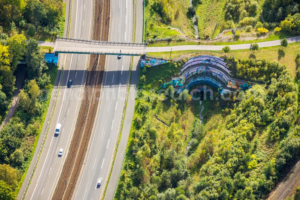 Dortmund from the bird's eye view: Graffiti- artwork and large-area painting on a facade of bridge along the Ruhrallee - B54 in the district Rombergpark in Dortmund at Ruhrgebiet in the state North Rhine-Westphalia, Germany