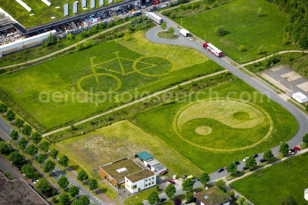 Hamm from the bird's eye view: Grassy areas with bicycle and ying-yang character structures in a field and meadow landscape in Hamm in North Rhine-Westphalia