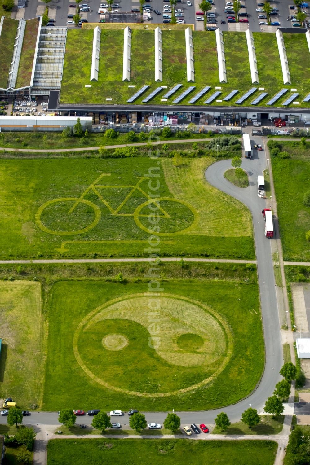 Aerial image Hamm - Grassy areas with bicycle and ying-yang character structures in a field and meadow landscape in Hamm in North Rhine-Westphalia