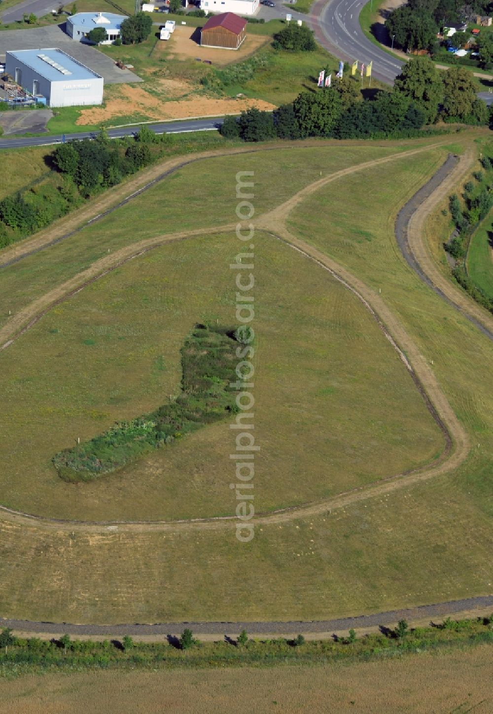 Aerial image Fürstenberg/Havel - Gras hill in the South of Fuerstenberg/Havel in the state Brandenburg. The hill with its circular paths and distinct gras and bush area on the plateau is located in the South of the town