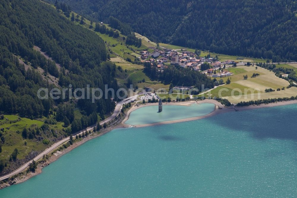 Aerial photograph Graun Im Vinschgau - View of the church steeple Alt-Graun in Vinschgau in Italy. At the beginning of the 20th century, all of the buildings in Alt-Graun were blown up, so the area could be used as a reservoir. In the background you can see the village Graun im Vinschgau