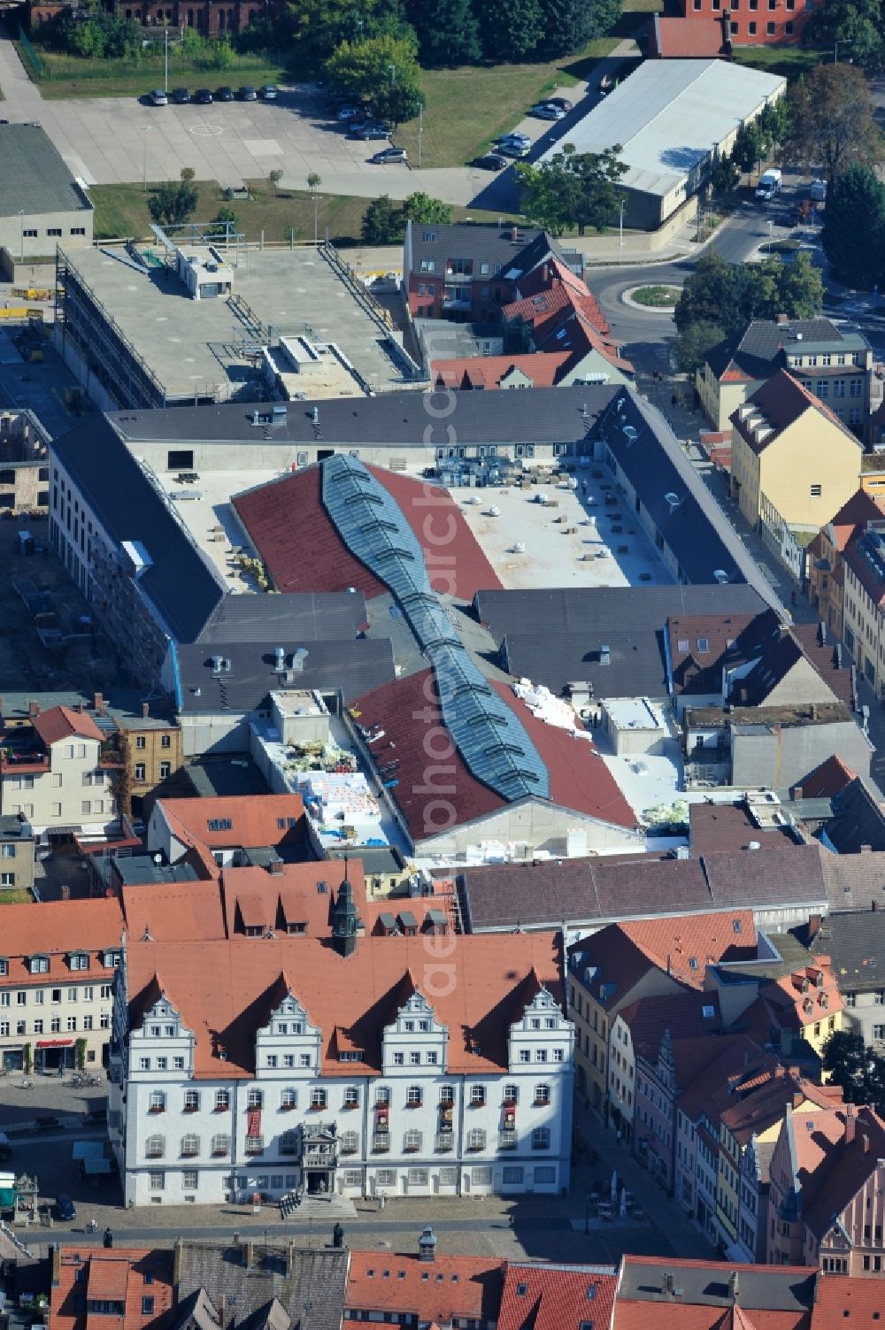 Aerial photograph Wittenberg - View of the construction site of the shopping center Arsenal between the Arsenal square and the market place in the inner city of Wittenberg. Project developers are MIB AG and the OFB Development GmbH. The completion is scheduled for autumn 2012