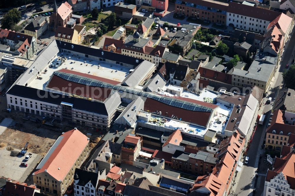 Aerial photograph Wittenberg - View of the construction site of the shopping center Arsenal between the Arsenal square and the market place in the inner city of Wittenberg. Project developers are MIB AG and the OFB Development GmbH. The completion is scheduled for autumn 2012