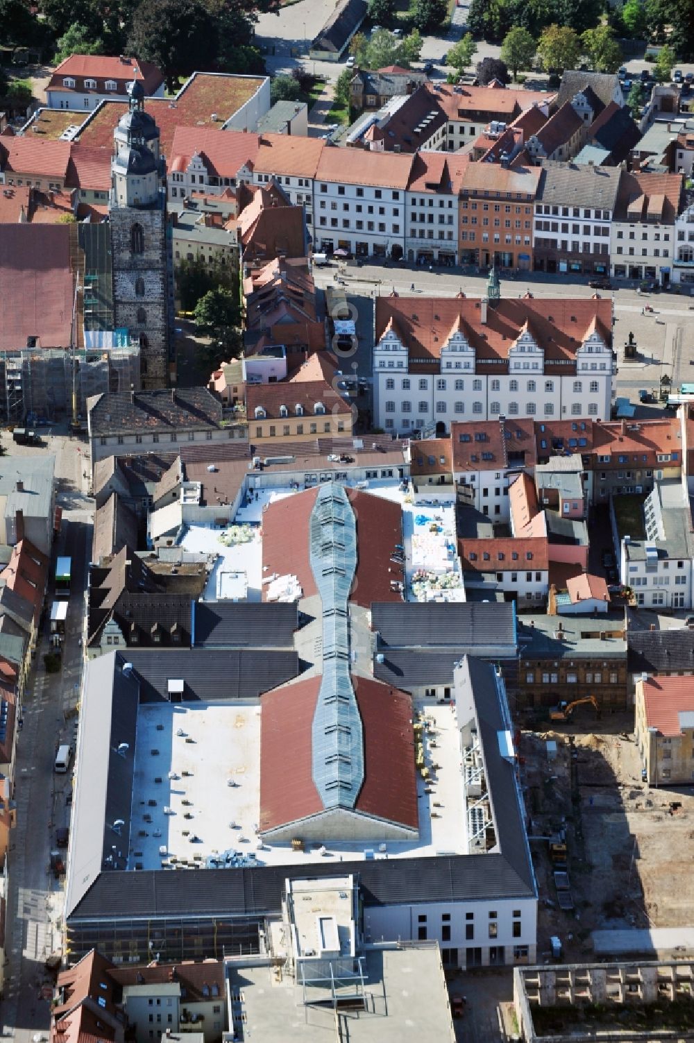 Aerial photograph Wittenberg - View of the construction site of the shopping center Arsenal between the Arsenal square and the market place in the inner city of Wittenberg. Project developers are MIB AG and the OFB Development GmbH. The completion is scheduled for autumn 2012