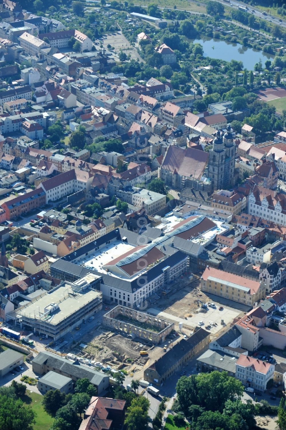 Aerial photograph Wittenberg - View of the construction site of the shopping center Arsenal between the Arsenal square and the market place in the inner city of Wittenberg. Project developers are MIB AG and the OFB Development GmbH. The completion is scheduled for autumn 2012