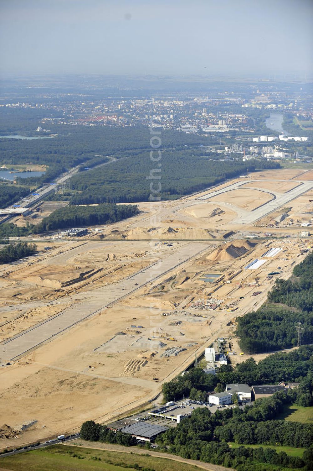 Frankfurt am Main from above - Blick auf die Großbaustelle der künftigen Landebahn Nordwest am FRAPORT Flughafen Frankfurt. Zu den Arbeiten, die vor dem Planieren der Bahn ablaufen mussten, gehörte auch die Errichtung unterirdischer Speicher- und Versickerbecken. Rund 400 Betonelemente, jeweils bis zu 32 Meter lang und 90 Tonnen schwer, wurden für die zwei Rollwege über die ICE-Trasse, die Autobahn A 3, den Airportring und eine Betriebsstraße verbaut. View of the construction site of the future runway Northwest at Fraport Frankfurt Airport.