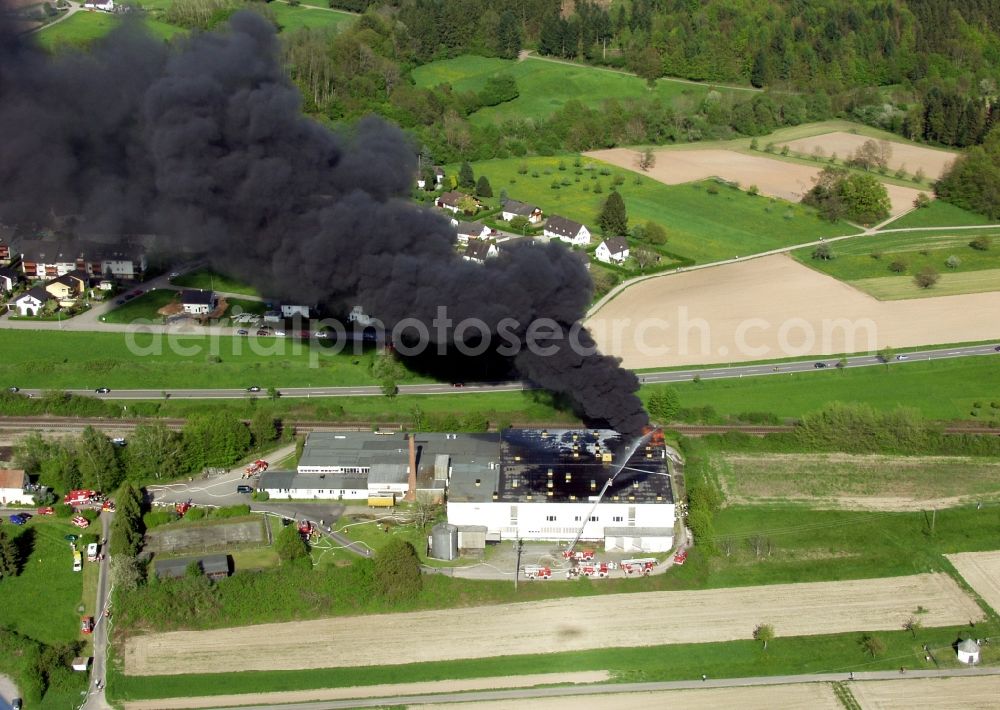 Wehr from above - Large fire at a warehouse in Wehr in the state of Baden-Wuerttemberg. By arson burn tires with black smoke