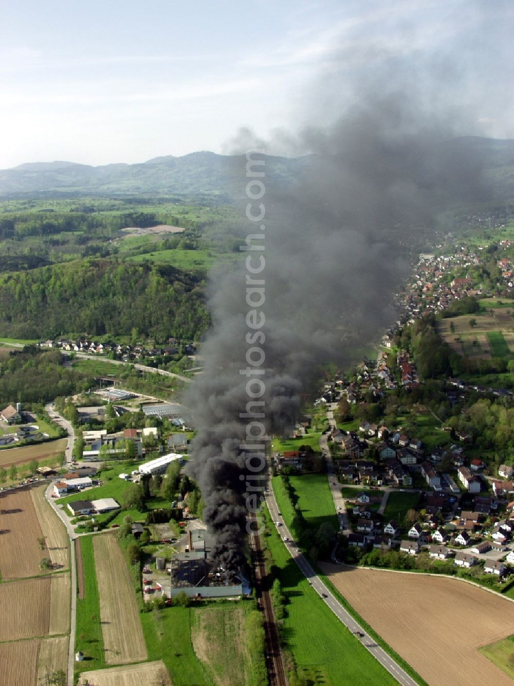 Aerial image Wehr - Large fire at a warehouse in Wehr in the state of Baden-Wuerttemberg. By arson burn tires with black smoke