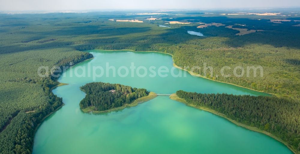 Wokuhl-Dabelow from above - Lake Grosser Brueckentinsee with its island and green water in the nature park Feldberger Seenlandschaft in Wokuhl-Dabelow in the state of Mecklenburg - Western Pomerania. The Island Hotel Brueckentinsee is located on the island