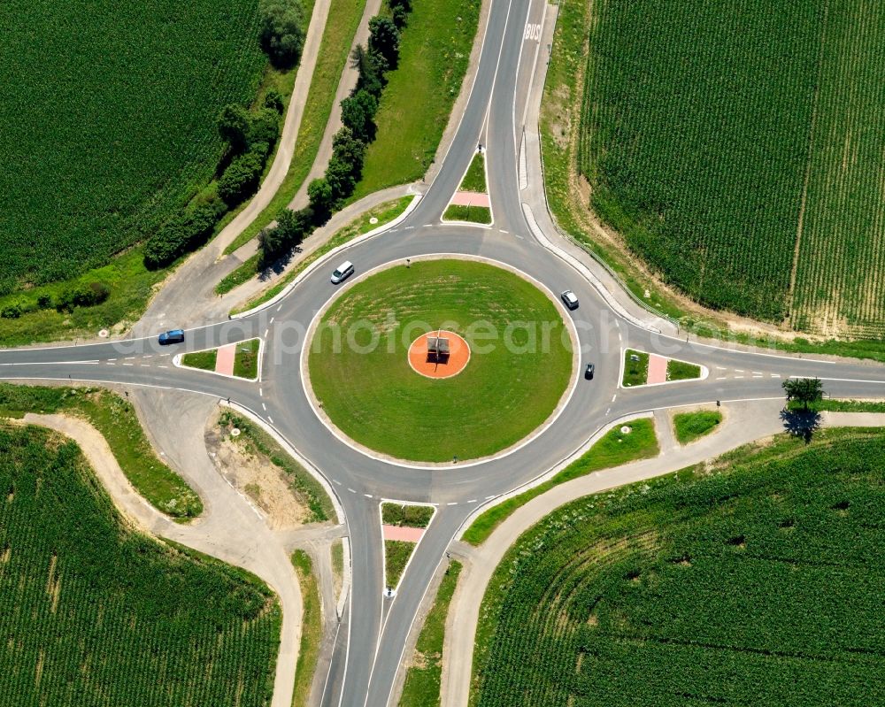 Eschbach from the bird's eye view: Large roundabout near Eschbach in the state of Baden-Wuerttemberg. The roundabout connects several traffic levels, streets and directions. It is not only an intersection for cars but also for pedestrians and cyclists. A red circle with a sculpture is sitting in its middle