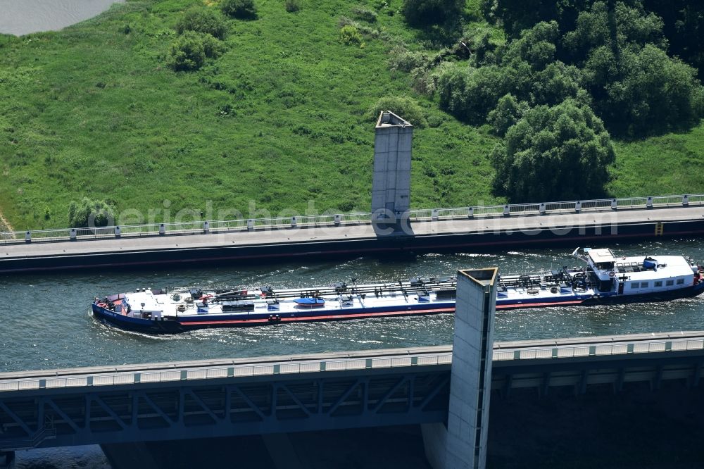 Hohenwarthe from above - Freight ship under way on the Trough bridge from the Mittelland Canal over the River Elbe to the Elbe-Havel Canal to the waterway intersection in Hohenwarthe in Saxony-Anhalt