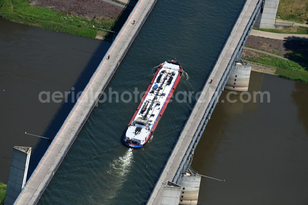 Hohenwarthe from above - Freight ship under way on the Trough bridge from the Mittelland Canal over the River Elbe to the Elbe-Havel Canal to the waterway intersection in Hohenwarthe in Saxony-Anhalt