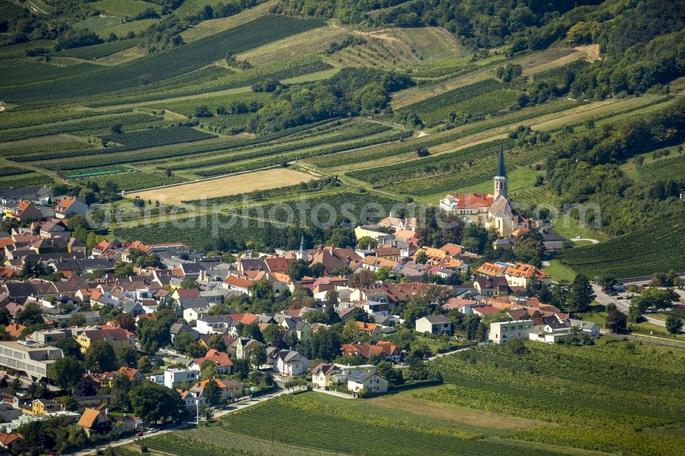 Guntramsdorf from above - The municipality Guntramsdorf in front of the hill Eichkogel in the state Lower Austria in Austria. The municipality is surrounded by fields