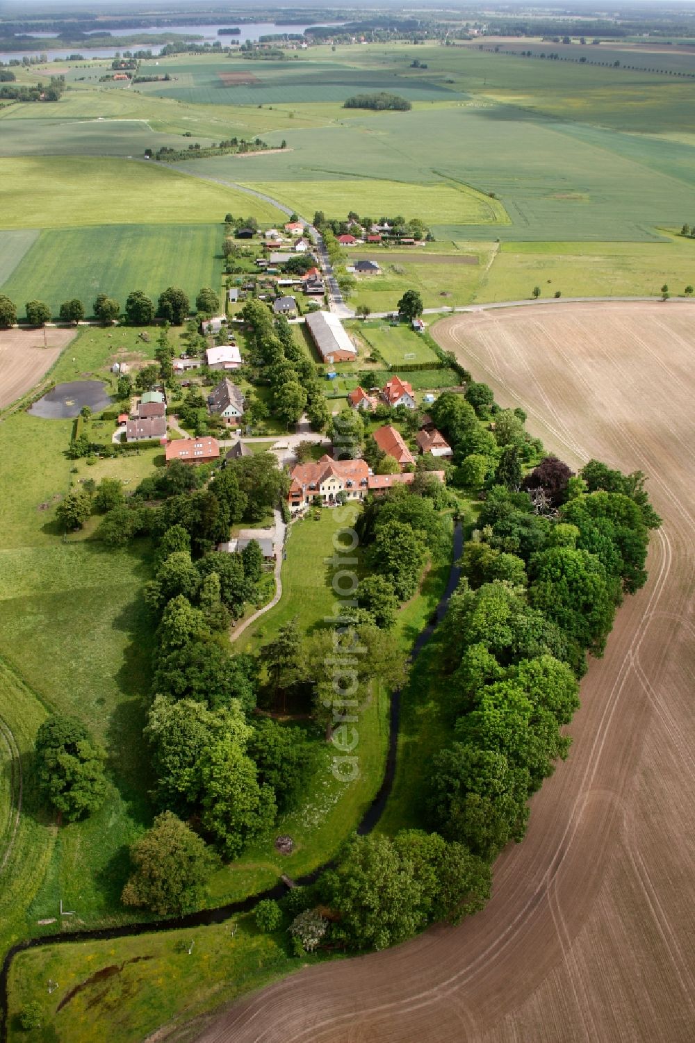 Aerial image Vipperow - Building complex of the manor house Solzow surrounded by green fields next to the park Gutshaus Solzow in the Lange Strasse in Vipperow in Mecklenburg-Western Pomerania