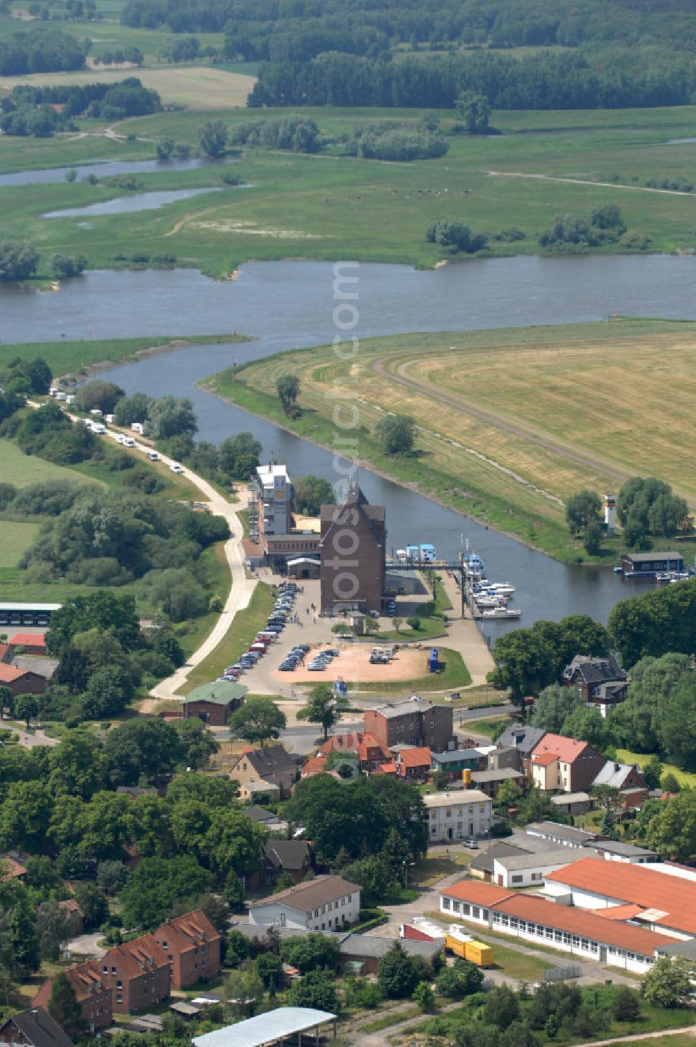 Dömitz from the bird's eye view: Blick auf den Hafen von Dömitz in Mecklenburg-Vorpommern. Die Stadt Dömitz an der Elbe liegt im Südwesten Mecklenburgs im Landkreis Ludwigslust. Der Hafen Dömitz bietet in den umgenutzten Speichergebäuden Erlebnisgastronomie mit einem Panorama Cafè, Fischrestaurant und Beachclub, sowie ein maritimes Hotel. Der Alte Speicher wird auch in der Saison für Kanu- oder Bootsverleih genutzt. Kontakt: Dömitzer Hafen Gastronomie GmbH & Co. KG, Hafenplatz 3, 19303 Dömitz, Tel.: 038758 / 364290,