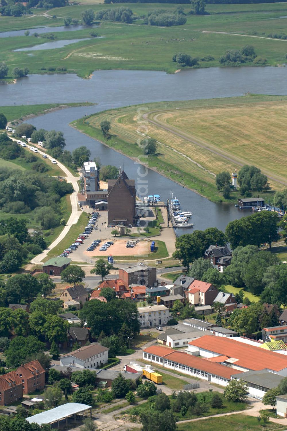 Aerial image Dömitz - Blick auf den Hafen von Dömitz in Mecklenburg-Vorpommern. Die Stadt Dömitz an der Elbe liegt im Südwesten Mecklenburgs im Landkreis Ludwigslust. Der Hafen Dömitz bietet in den umgenutzten Speichergebäuden Erlebnisgastronomie mit einem Panorama Cafè, Fischrestaurant und Beachclub, sowie ein maritimes Hotel. Der Alte Speicher wird auch in der Saison für Kanu- oder Bootsverleih genutzt. Kontakt: Dömitzer Hafen Gastronomie GmbH & Co. KG, Hafenplatz 3, 19303 Dömitz, Tel.: 038758 / 364290,