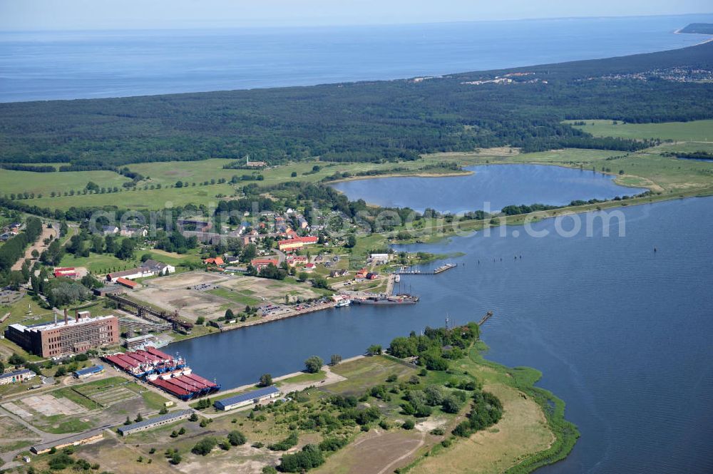 Peenemünde from above - Blick auf den Hafen Peenemünde und das Entwicklungsgebiet auf der ehemaligen Marinebasis auf der Insel Usedom. Das unter Denkmalschutz stehende alte Kraftwerk ist als Museum ein Touristenmagnet. Auf dem Gelände der ehemaligen NVA-Marinebasis entstehen nach umfassenden Abriß- und Räumungsarbeiten moderne Mehr- und Einfamilienhäuser. View of the Port Peenemünde and the development area on the former military base on the island of Usedom.