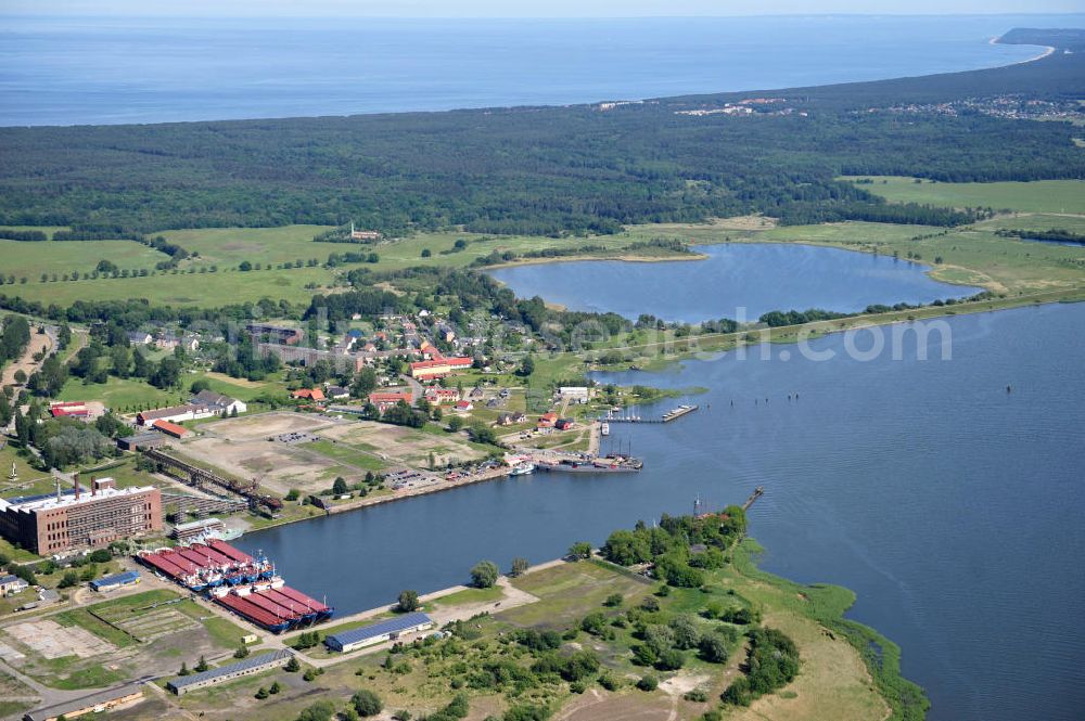 Aerial image Peenemünde - Blick auf den Hafen Peenemünde und das Entwicklungsgebiet auf der ehemaligen Marinebasis auf der Insel Usedom. Das unter Denkmalschutz stehende alte Kraftwerk ist als Museum ein Touristenmagnet. Auf dem Gelände der ehemaligen NVA-Marinebasis entstehen nach umfassenden Abriß- und Räumungsarbeiten moderne Mehr- und Einfamilienhäuser. View of the Port Peenemünde and the development area on the former military base on the island of Usedom.