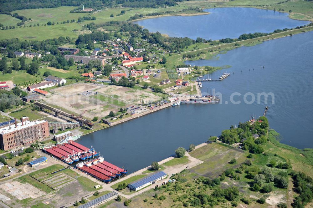 Peenemünde from the bird's eye view: Blick auf den Hafen Peenemünde und das Entwicklungsgebiet auf der ehemaligen Marinebasis auf der Insel Usedom. Das unter Denkmalschutz stehende alte Kraftwerk ist als Museum ein Touristenmagnet. Auf dem Gelände der ehemaligen NVA-Marinebasis entstehen nach umfassenden Abriß- und Räumungsarbeiten moderne Mehr- und Einfamilienhäuser. View of the Port Peenemünde and the development area on the former military base on the island of Usedom.