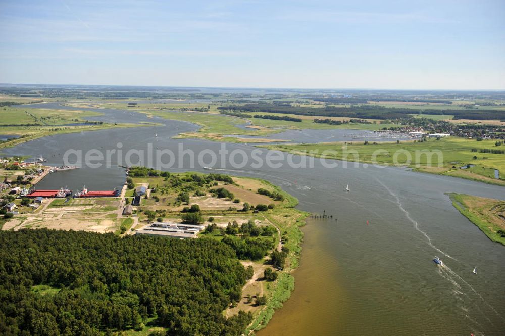 Peenemünde from above - Blick auf den Hafen Peenemünde und das Entwicklungsgebiet auf der ehemaligen Marinebasis auf der Insel Usedom. Das unter Denkmalschutz stehende alte Kraftwerk ist als Museum ein Touristenmagnet. Auf dem Gelände der ehemaligen NVA-Marinebasis entstehen nach umfassenden Abriß- und Räumungsarbeiten moderne Mehr- und Einfamilienhäuser. View of the Port Peenemünde and the development area on the former military base on the island of Usedom.