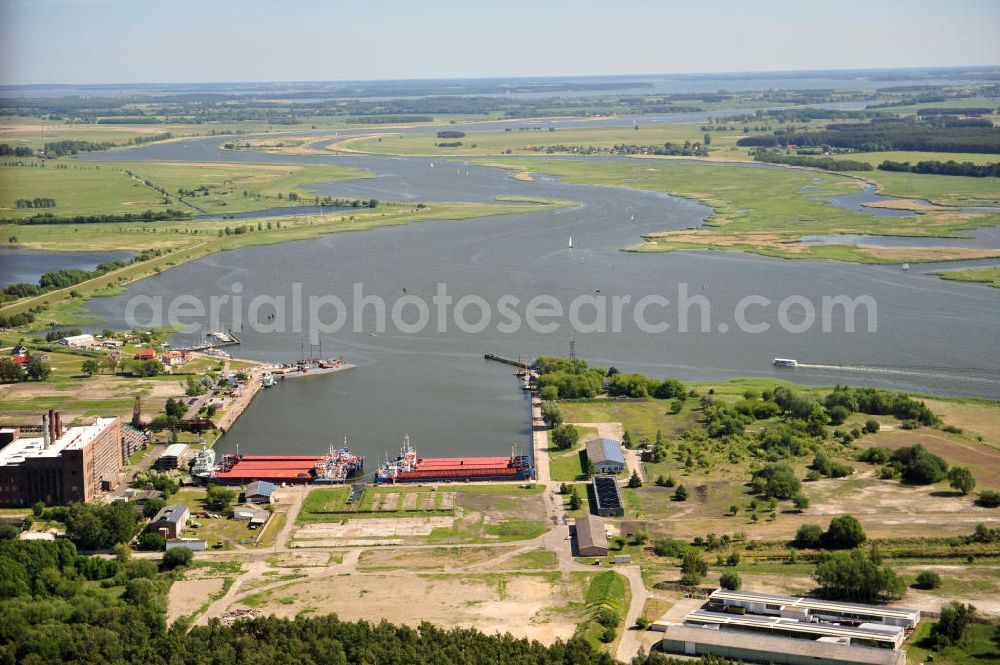 Peenemünde from the bird's eye view: Blick auf den Hafen Peenemünde und das Entwicklungsgebiet auf der ehemaligen Marinebasis auf der Insel Usedom. Das unter Denkmalschutz stehende alte Kraftwerk ist als Museum ein Touristenmagnet. Auf dem Gelände der ehemaligen NVA-Marinebasis entstehen nach umfassenden Abriß- und Räumungsarbeiten moderne Mehr- und Einfamilienhäuser. View of the Port Peenemünde and the development area on the former military base on the island of Usedom.