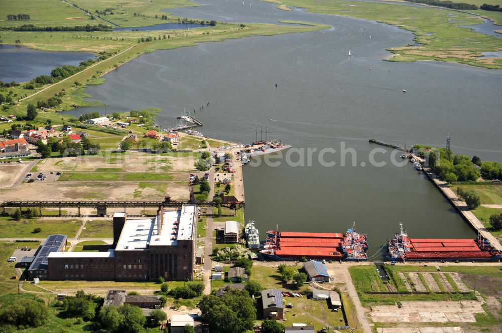 Peenemünde from above - Blick auf den Hafen Peenemünde und das Entwicklungsgebiet auf der ehemaligen Marinebasis auf der Insel Usedom. Das unter Denkmalschutz stehende alte Kraftwerk ist als Museum ein Touristenmagnet. Auf dem Gelände der ehemaligen NVA-Marinebasis entstehen nach umfassenden Abriß- und Räumungsarbeiten moderne Mehr- und Einfamilienhäuser. View of the Port Peenemünde and the development area on the former military base on the island of Usedom.