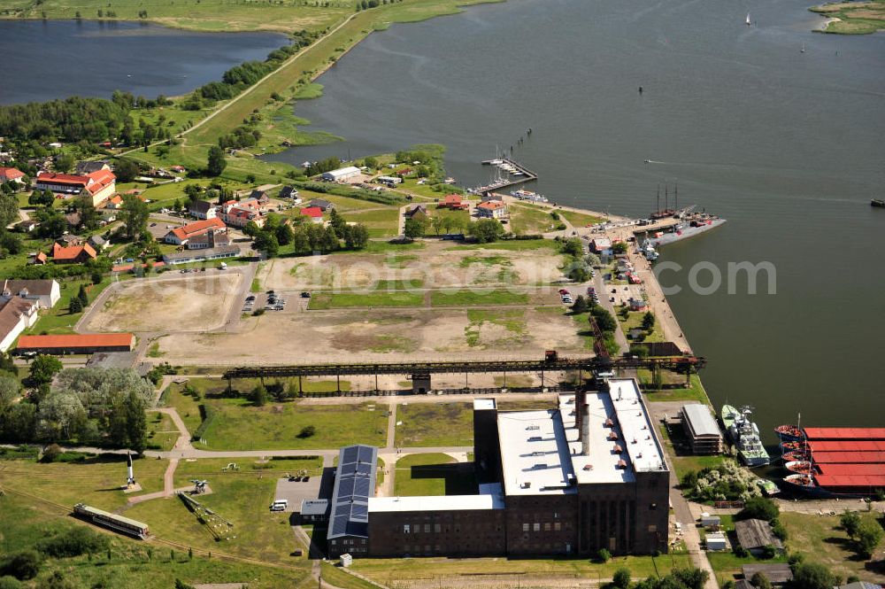 Peenemünde from the bird's eye view: Blick auf den Hafen Peenemünde und das Entwicklungsgebiet auf der ehemaligen Marinebasis auf der Insel Usedom. Das unter Denkmalschutz stehende alte Kraftwerk ist als Museum ein Touristenmagnet. Auf dem Gelände der ehemaligen NVA-Marinebasis entstehen nach umfassenden Abriß- und Räumungsarbeiten moderne Mehr- und Einfamilienhäuser. View of the Port Peenemünde and the development area on the former military base on the island of Usedom.