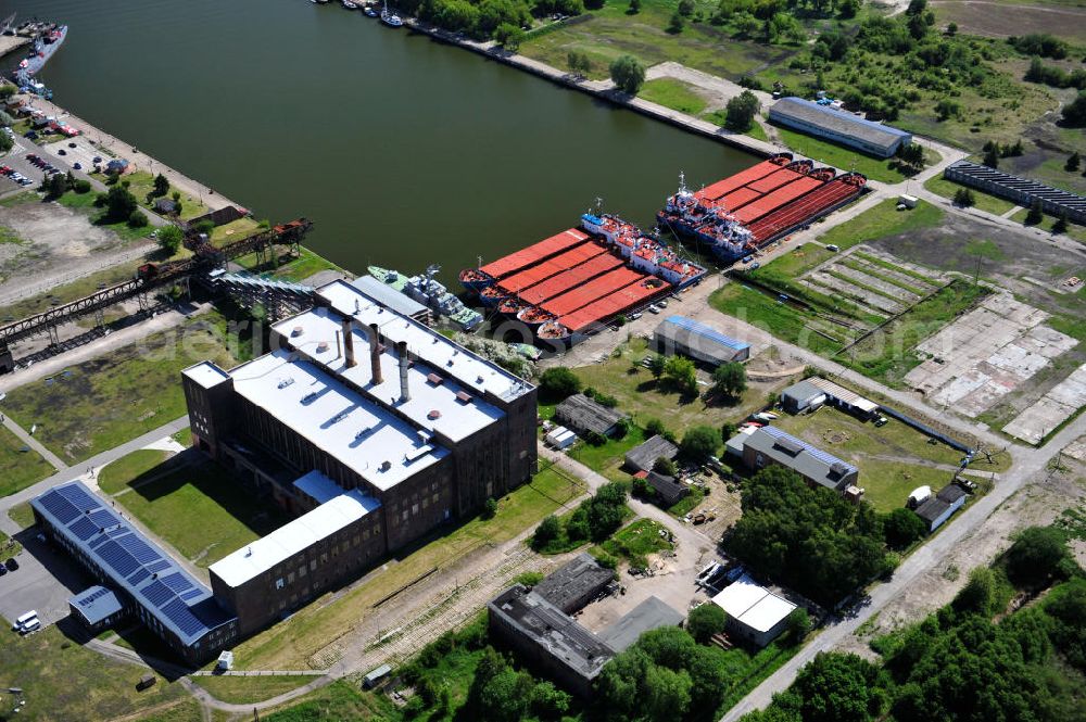 Aerial photograph Peenemünde - Blick auf den Hafen Peenemünde und das Entwicklungsgebiet auf der ehemaligen Marinebasis auf der Insel Usedom. Das unter Denkmalschutz stehende alte Kraftwerk ist als Museum ein Touristenmagnet. Auf dem Gelände der ehemaligen NVA-Marinebasis entstehen nach umfassenden Abriß- und Räumungsarbeiten moderne Mehr- und Einfamilienhäuser. View of the Port Peenemünde and the development area on the former military base on the island of Usedom.