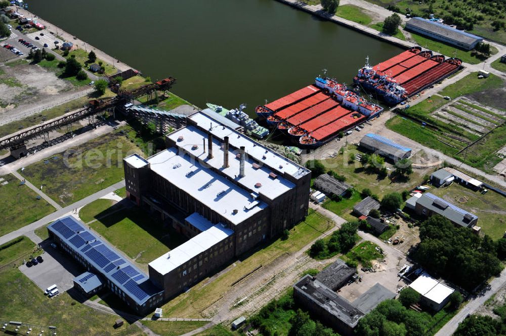 Peenemünde from above - Blick auf den Hafen Peenemünde und das Entwicklungsgebiet auf der ehemaligen Marinebasis auf der Insel Usedom. Das unter Denkmalschutz stehende alte Kraftwerk ist als Museum ein Touristenmagnet. Auf dem Gelände der ehemaligen NVA-Marinebasis entstehen nach umfassenden Abriß- und Räumungsarbeiten moderne Mehr- und Einfamilienhäuser. View of the Port Peenemünde and the development area on the former military base on the island of Usedom.