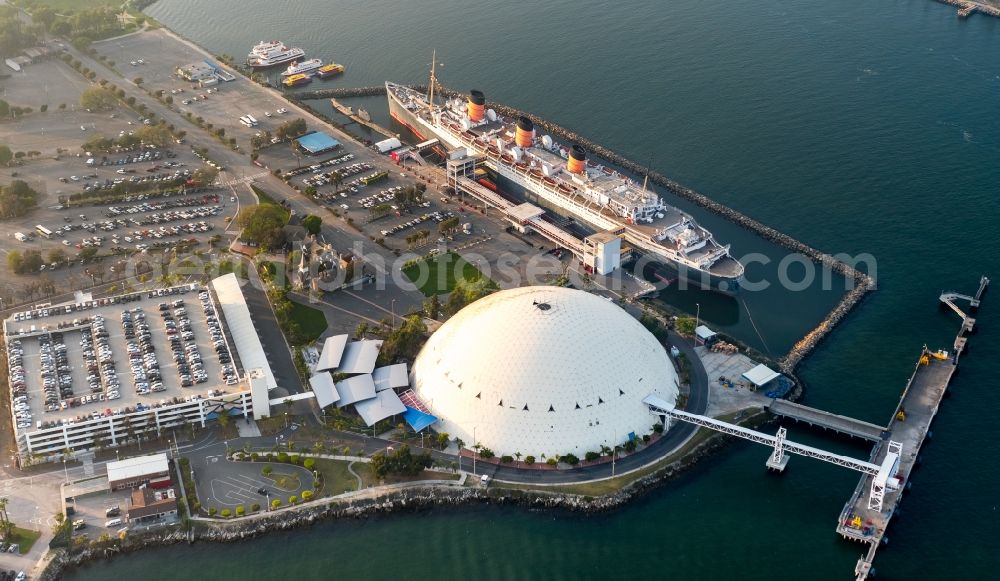 Aerial image Long Beach - Port facilities of Carnival Cruise Lines with a white dome and Hotel ship The Queen Mary in Long Beach in California, USA