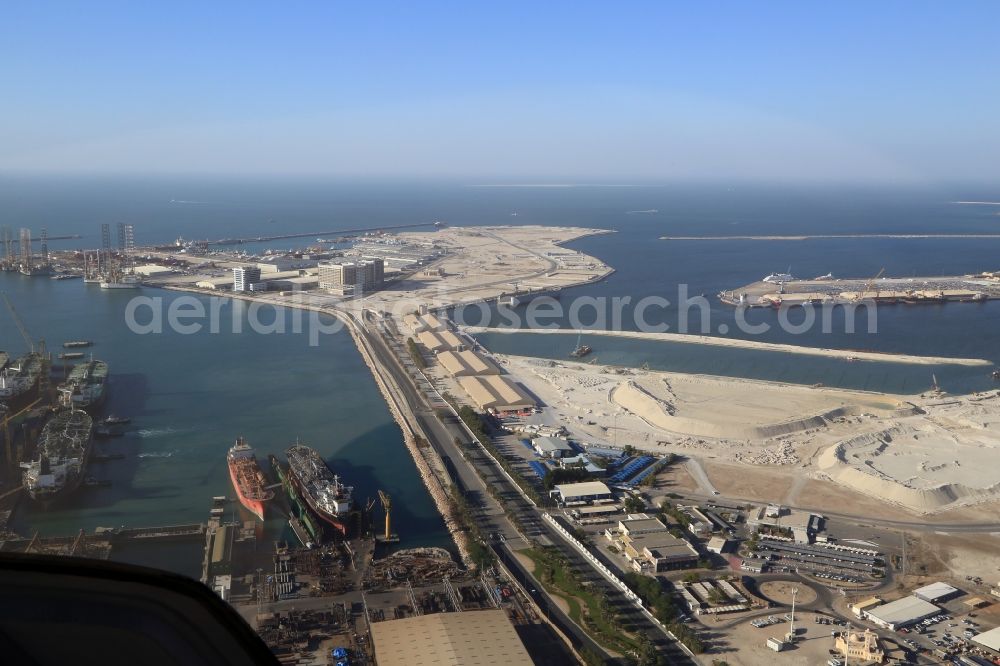 Dubai from the bird's eye view: Port facilities and construction sites on the man-made Dubai Maritime City off the coast of Dubai in the United Arab Emirates