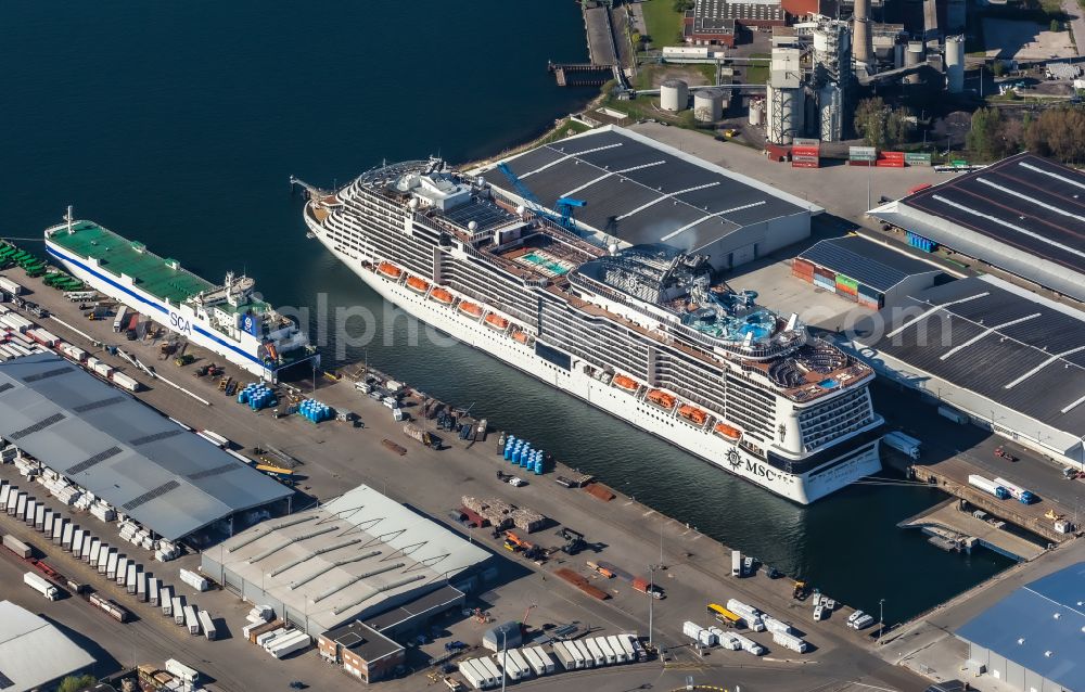 Aerial image Kiel - Port facilities with a cruise ship on the banks of the Ostuferhafen harbor basin in Kiel in the state Schleswig-Holstein, Germany. Freight ferry from SCA Logistics GmbH (Swedish Zellulose-AG) and cruise ship MSC Meraviglia at the Ostuferhafen cruise terminal