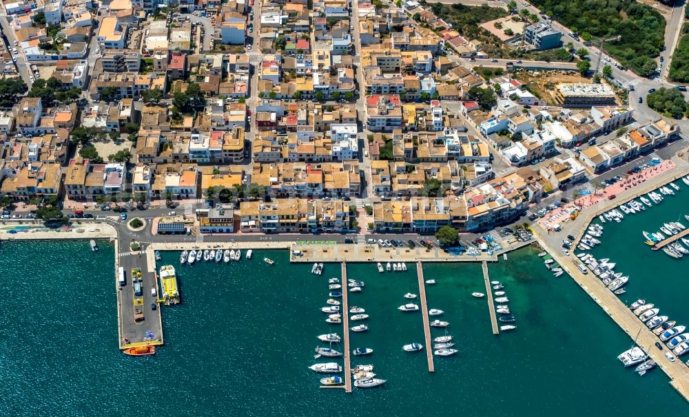 Aerial image Portocolom - Port facilities on the seashore in the residential area on Carrer dels Pescadors in Portocolom in Balearic island of Mallorca, Spain