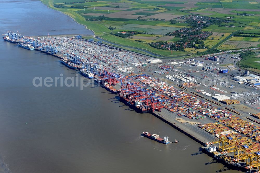 Bremerhaven from the bird's eye view: Docks and terminals with warehouses, freight forwarding and logistics companies and lots of containers by the mouth of the Weser in Bremerhaven in the state Bremen