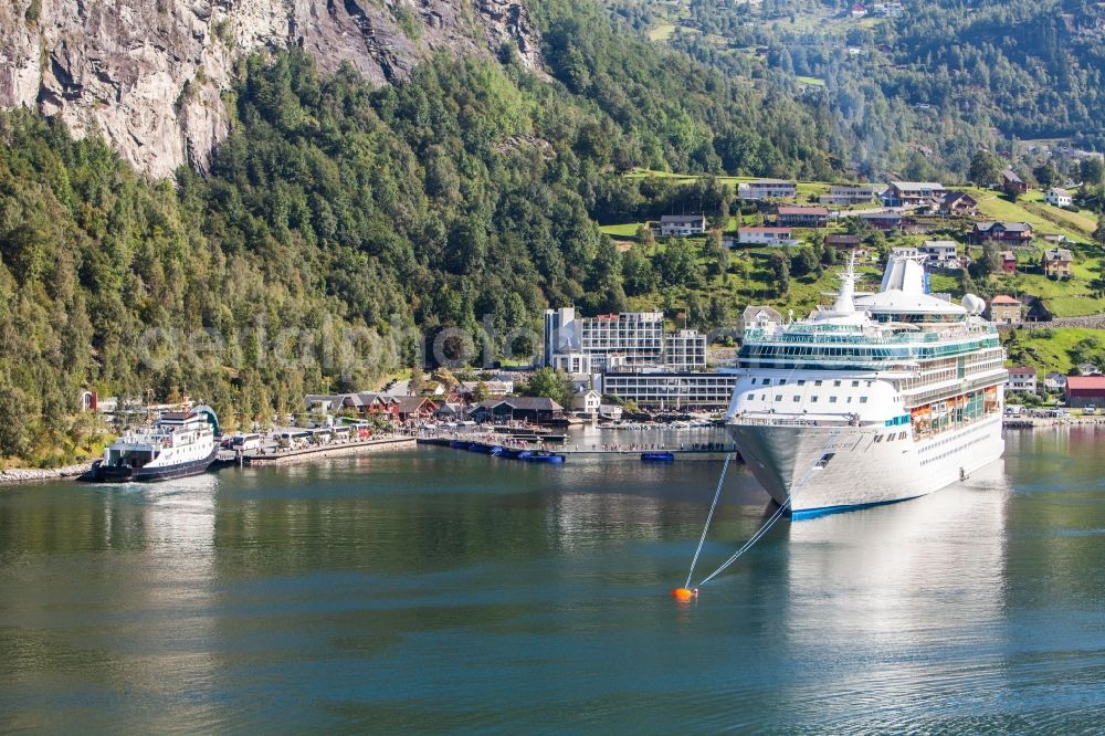 Geiranger from the bird's eye view: Cruise Ship in Port facilities on the shores of the harbor of in Fjord of Geiranger in Moere og Romsdal, Norway