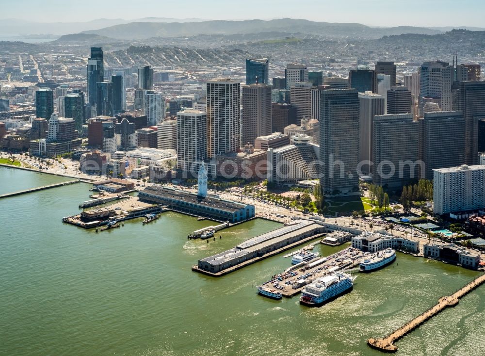 Aerial image San Francisco - Port facilities and white clock tower on the shores of the harbor of des Ferry Terminal in San Francisco in USA