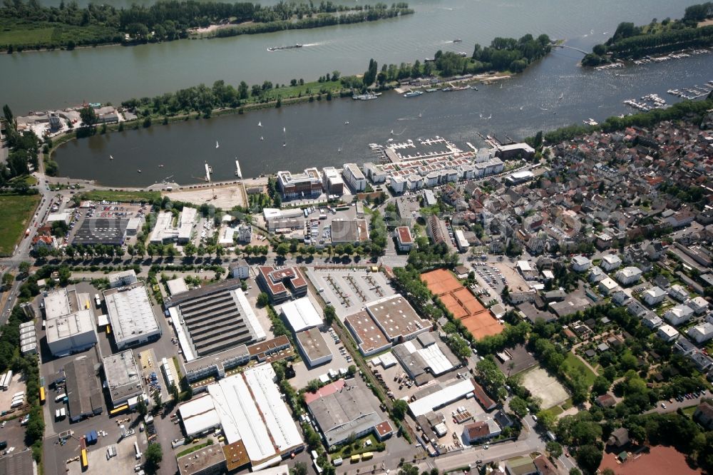 Wiesbaden Schierstein from the bird's eye view: View of the city district with residential area, port and industrial area. Schier stone has a town center with narrow streets and many small older houses down to the harbor road. This serves as a promenade on Schiersteiner harbor, the pool is enlivened by many jetties and corresponding boat traffic. Around the village there businesses have settled. The Schiersteiner harbor situated on the Rhine and is a water sports center of the Hessian capital Wiesbaden