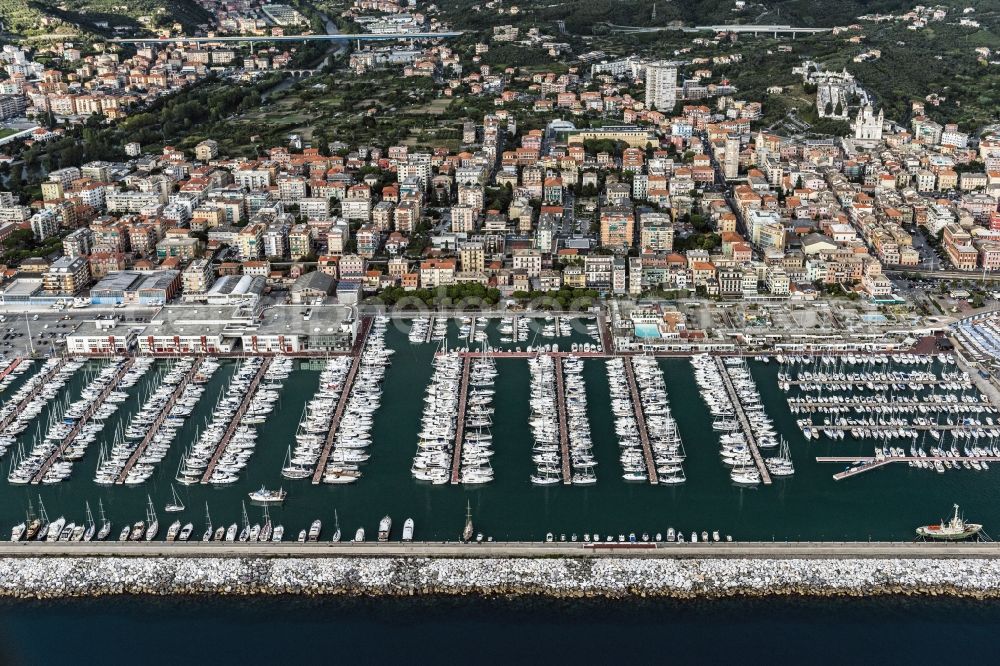 Lavagna from the bird's eye view: Mole with rows of sportboats in the marina of the city Lavagna on the mediterranean coast in Liguria in Italy. The Entella river crosses the city. The banks are lined with trees