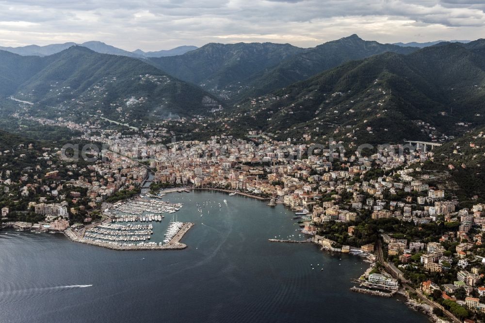 Aerial photograph Rapallo - View on the harbor and the city Rapallo with a row of houses on the shore of the river Milano on the Mediterranean coast in Liguria in Italy. Mountains of the Alps are visible in background