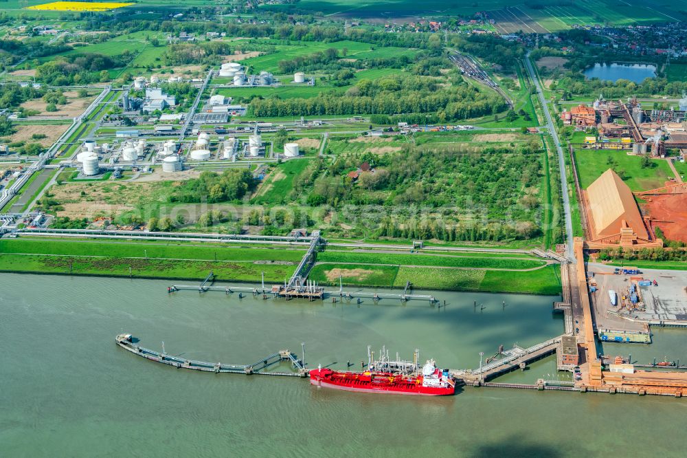 Stade from above - Port facility Stader Seehafen AOS am Buetzflether Sand in Buetzfleth in the state Lower Saxony, Germany. The Hanseatic Energy Hub is to be built on the green space by 2026. The planned terminal for the import of liquefied natural gas (LNG) will be integrated into the existing industrial park