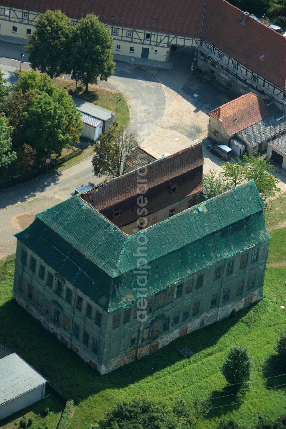 Aerial image Langenleuba-Niederhain - Halbes Schloss Castle in the village centre of Langenleuba-Niederhain in the state of Thuringia. The historic building is being renovated