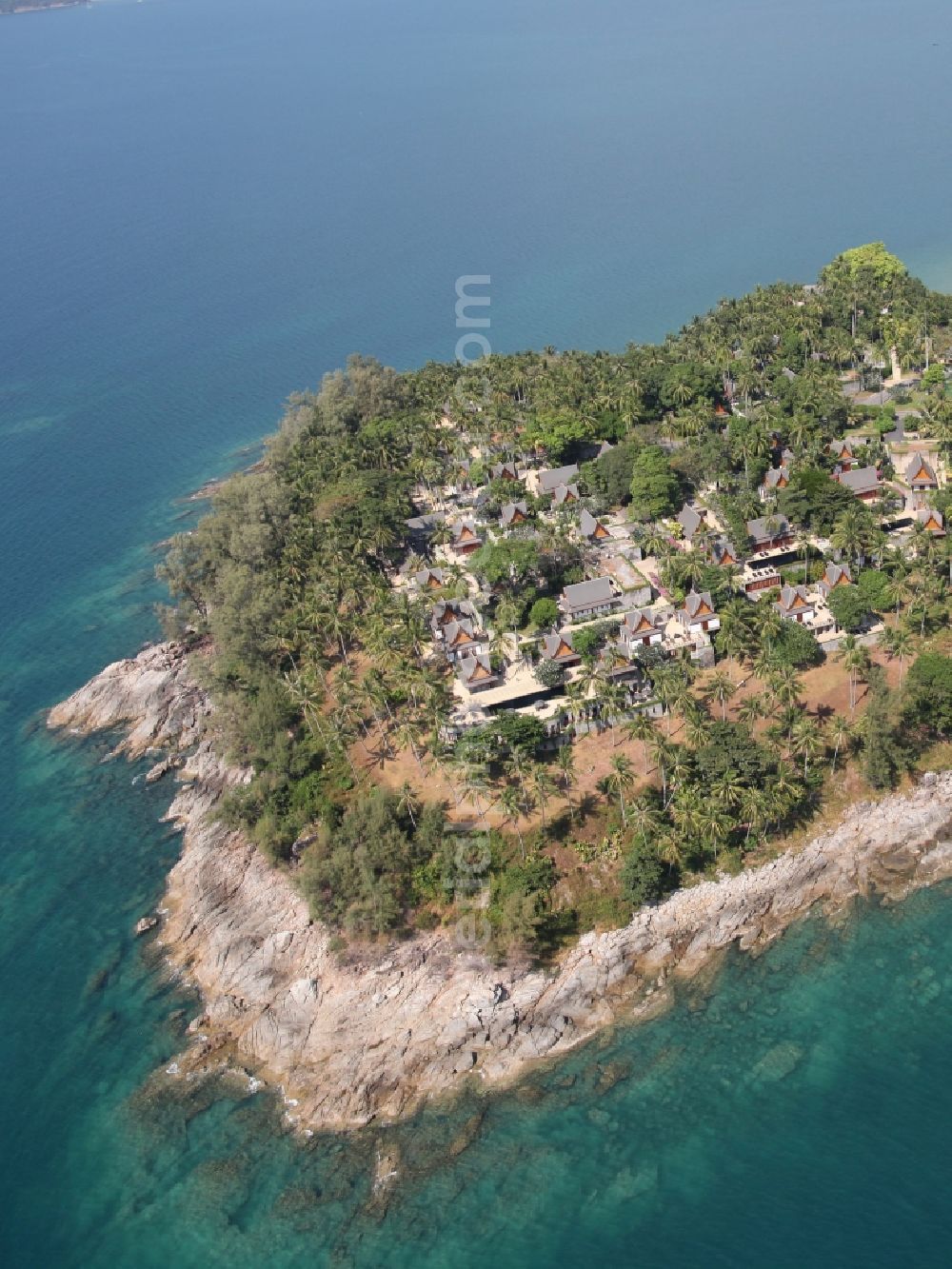 Choeng Thale from the bird's eye view: Peninsula at Choeng Thale on the island of Phuket in Thailand. On it is located the Amanpuri Resort, a luxury hotel under palm trees