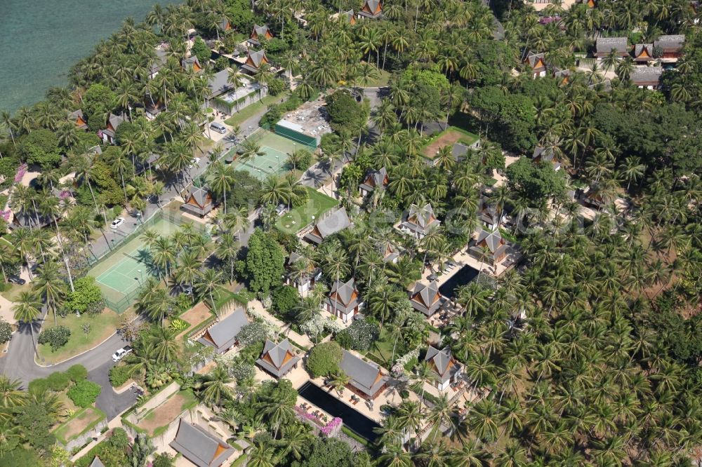 Aerial image Choeng Thale - Peninsula at Choeng Thale on the island of Phuket in Thailand. On it is located the Amanpuri Resort, a luxury hotel under palm trees